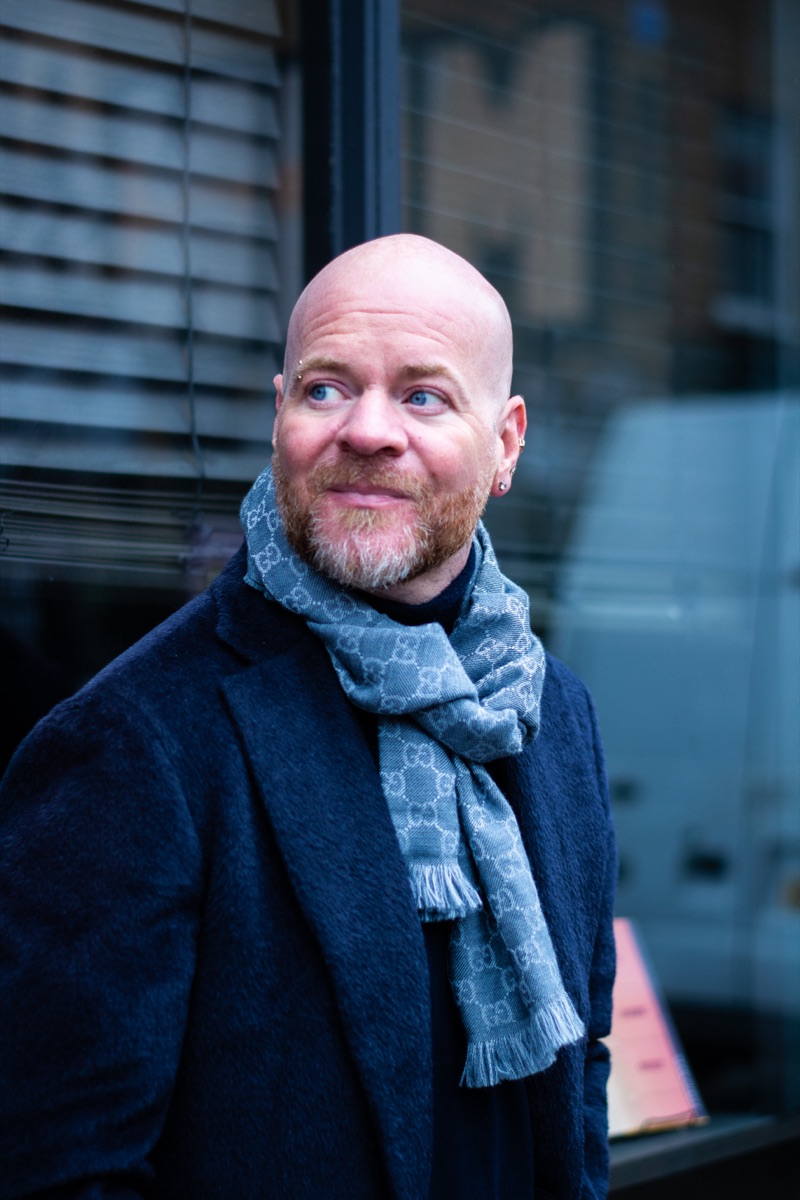 Carl Reader, Gucci scarf, navy coat, smile