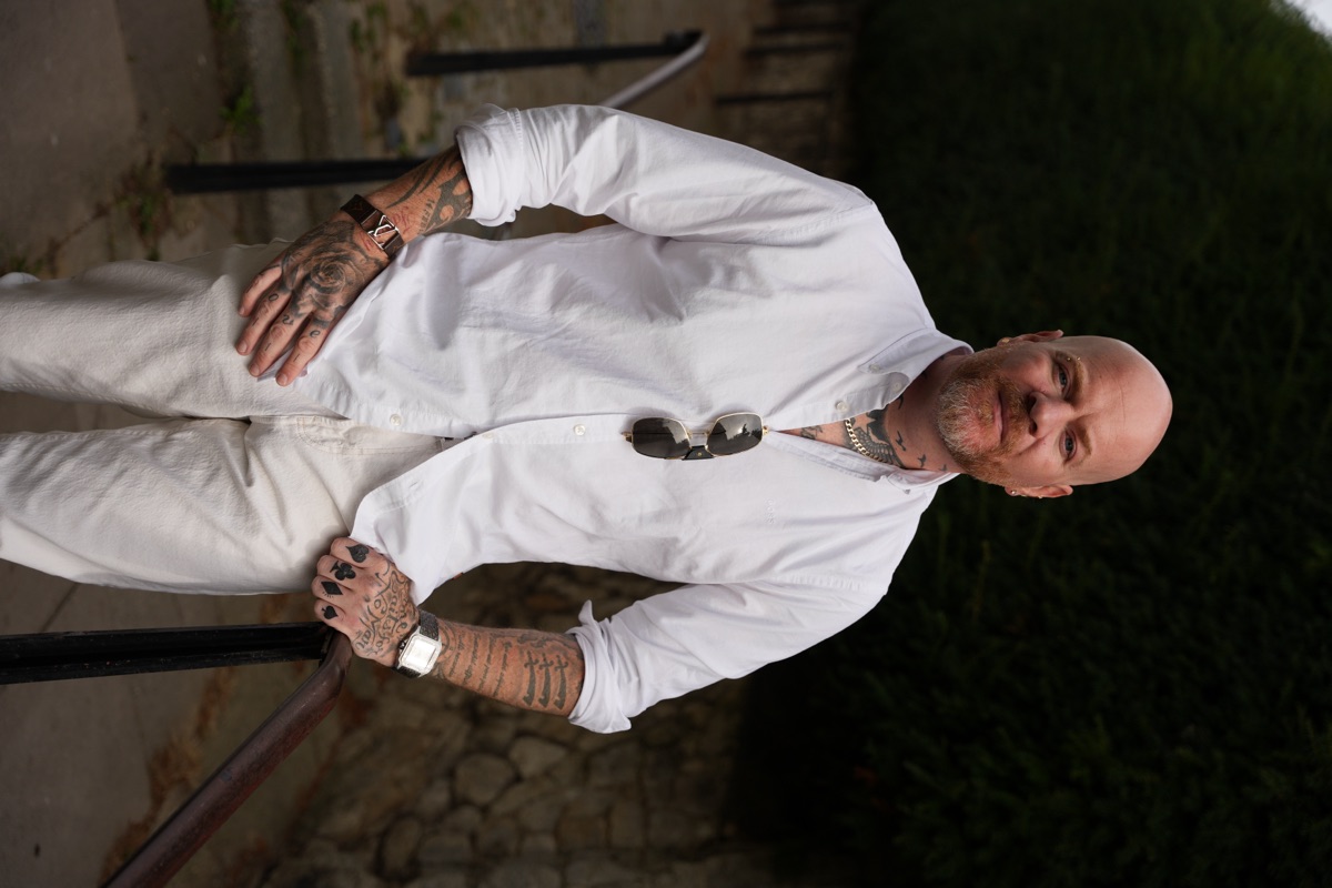 Carl Reader, white shirt on stair handrail