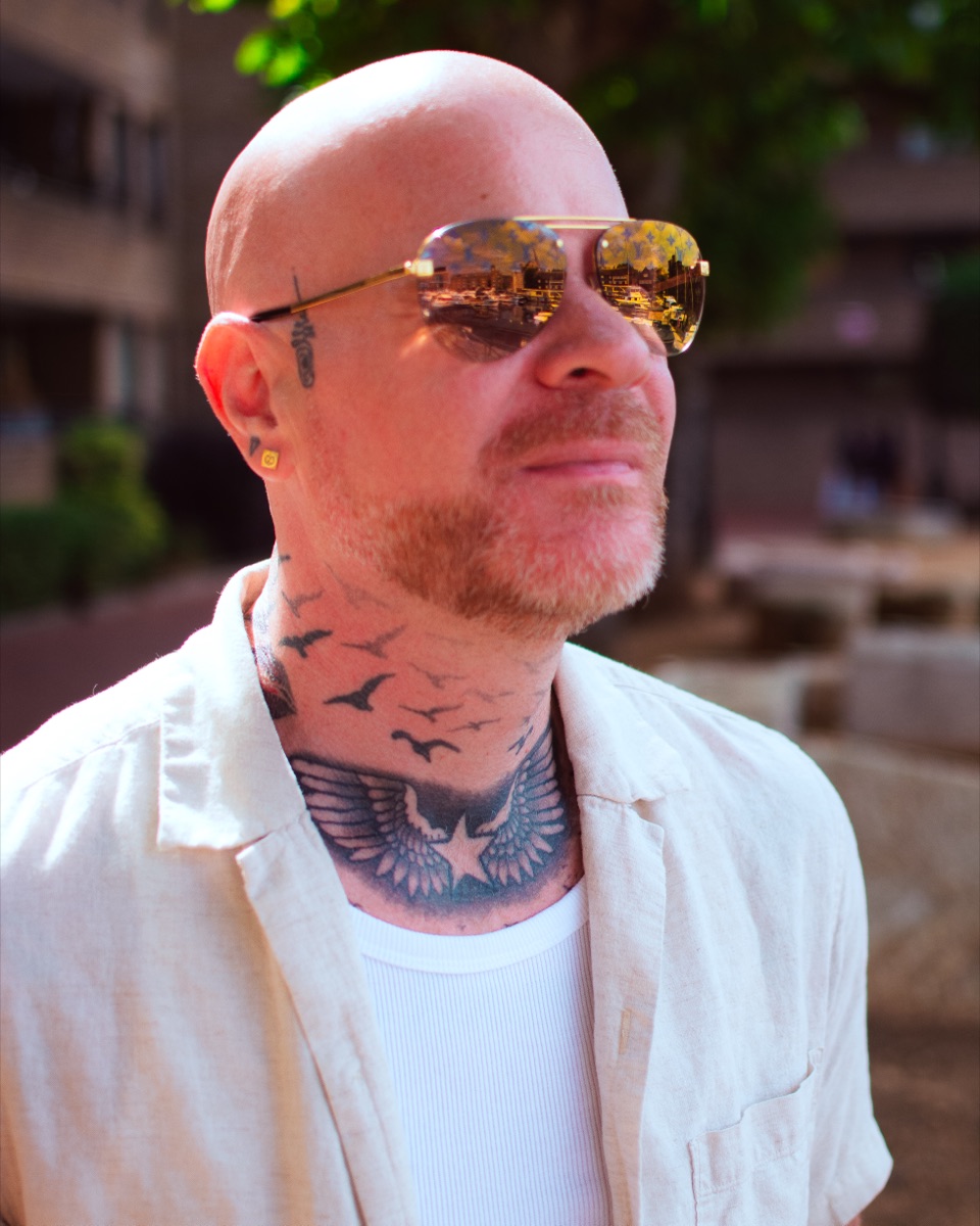 Carl Reader, cream linen shirt, gold sunglasses