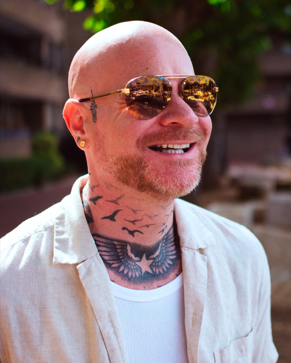 Carl Reader, cream linen shirt, smiling